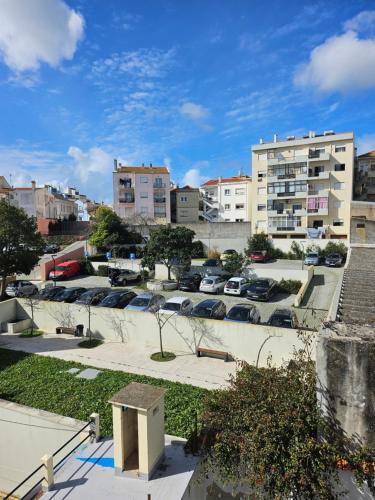 a parking lot with parked cars in a city at Sun with Style in Figueira da Foz