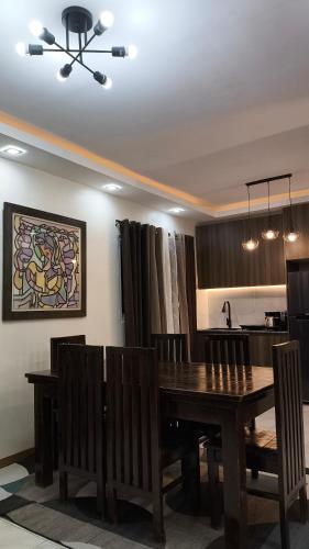 a dining room with a wooden table and chairs at Davao Transient House in Davao City
