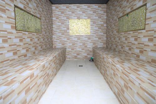 a room with wooden benches in a brick wall at My dream apartment in Addis Ababa
