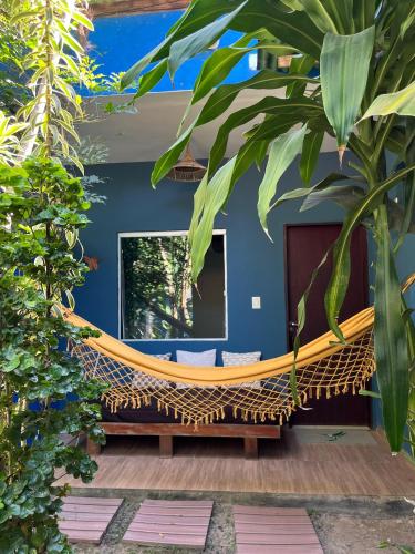 a hammock in the middle of a house at Villa Residencial Encantos Da Mata in Itacaré