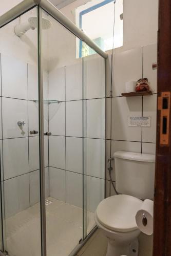 a bathroom with a shower and a toilet at Villa Residencial Encantos Da Mata in Itacaré
