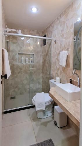 a bathroom with a shower and a toilet and a sink at Hotel Brasil PREMIUM 604 in Fortaleza