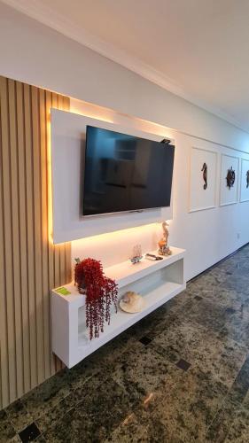 a white shelf with a television on a wall at Hotel Brasil T Sensacional PREMIUM in Fortaleza