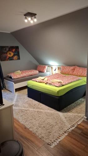two beds sitting in a room with a rug at Glücksburg Strandnah an der Förde in Glücksburg