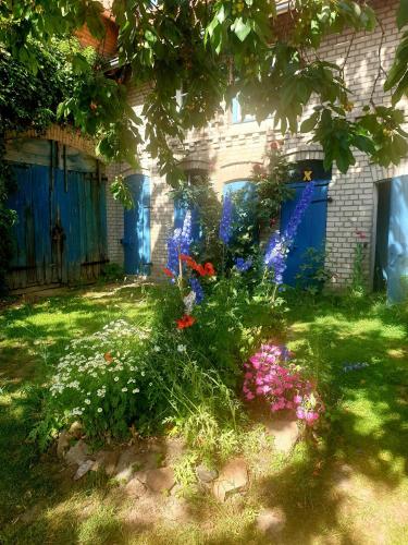 a garden with flowers in front of a house at Historic Farm House In The Wendland Region in Beesem