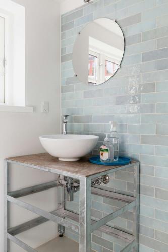 a bathroom with a sink and a mirror at The Soulful Town House In The Heart Of Faaborg in Fåborg