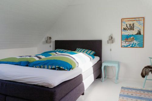 a bedroom with a bed with blue and white sheets at The Soulful Town House In The Heart Of Faaborg in Fåborg