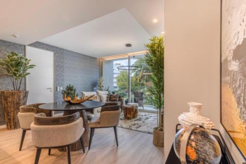a dining room with a table and chairs at Infinity Haven in Funchal