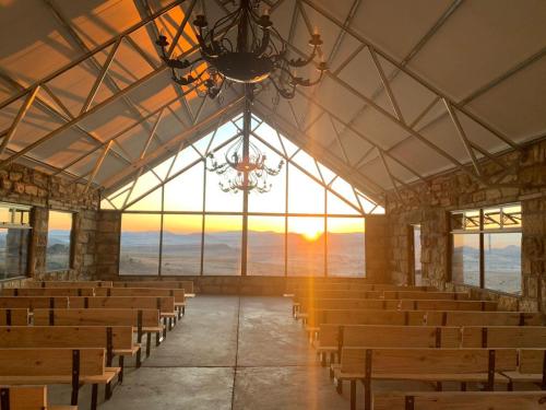an empty church with chairs and a chandelier at Uitzicht Private Nature Reserve and Lodge in Fouriesburg