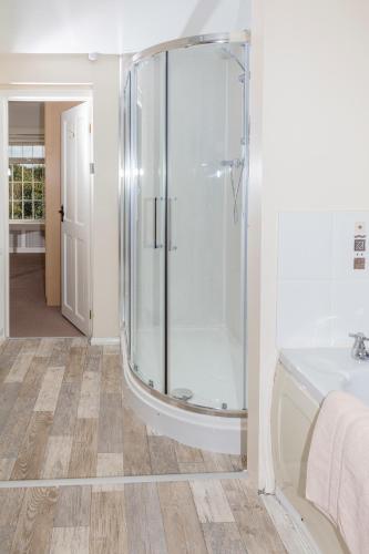 a bathroom with a shower and a tub at Whittonlodge sleeps28 Hottub pool table in Hardstoft