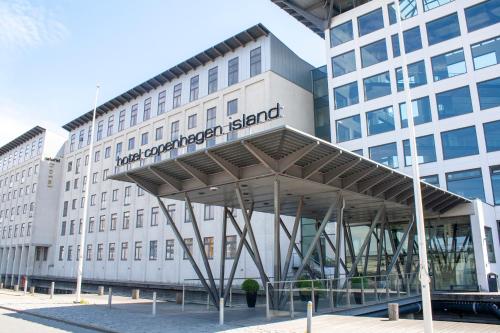 a building with a sign on the front of it at Copenhagen Island Hotel in Copenhagen