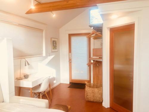a bedroom with a bed and a desk and a sink at Star Studio, A Modern Dream in Eugene