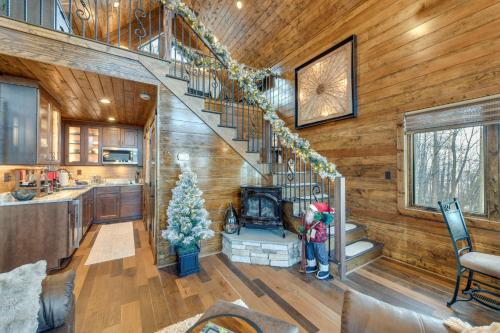 a woman standing in a living room with a staircase in a house at Couples Getaway in Stoney Creek at Wintergreen! in Nellysford