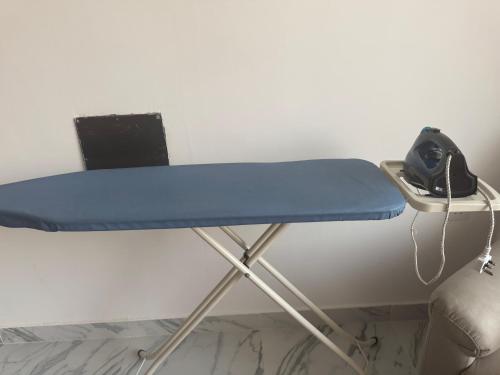 a desk with a blue table and a chair at Homestay Cozy bedroom with private attached washroom in ajman villa in Ajman
