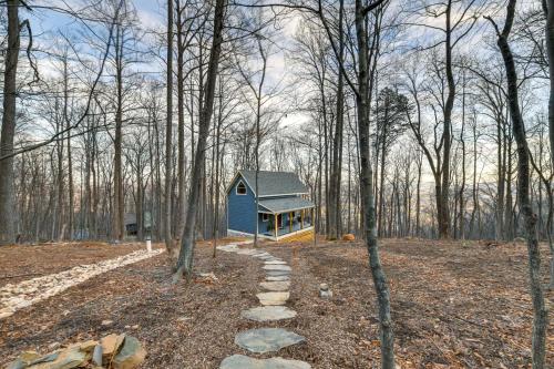 a small blue house in the middle of the woods at Couples Getaway in Stoney Creek at Wintergreen! in Nellysford