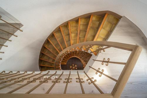 a spiral stairway with a circular staircase in a room at Villa DEA - Home away from home - Families Only in Salou