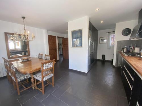 a kitchen and dining room with a table and chairs at Villa DEA - Home away from home - Families Only in Salou