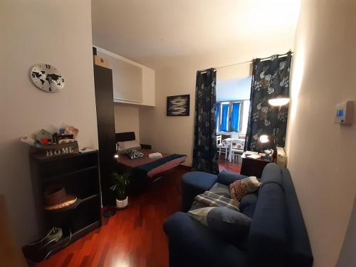 a living room with a blue couch and a table at Trilly's House is waiting for you! Panoramic Penthouse in Florence