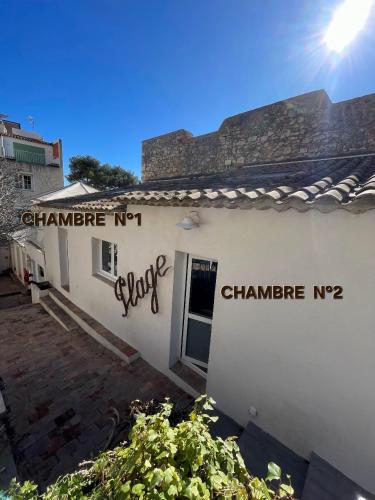 a white building with graffiti on the side of it at Hotel de La Plage - Mahogany in Cassis