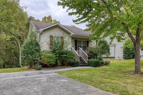 a house with a tree and a driveway at Henderson's Riverside in Pigeon Forge