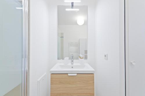 a bathroom with a sink and a mirror at Cozy studio near Paris & Orly in Vigneux-sur-Seine