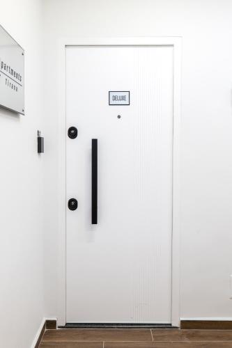 a pair of white doors in a white wall at AL Apartments Tirana in Tirana