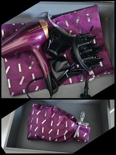 a purple hairdryer and a hair dryer in a box at Maison entière avec espace cinéma in Riom