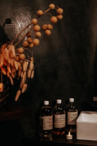 three bottles of alcohol sitting on a table with a bunch of nuts at Riad Villa Wengé & Spa in Marrakech