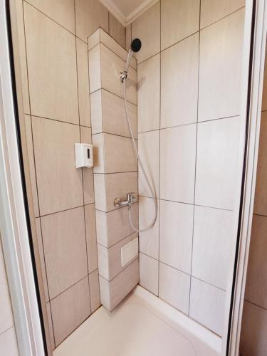 a shower with a shower head in a bathroom at Arsenal in Daugavpils