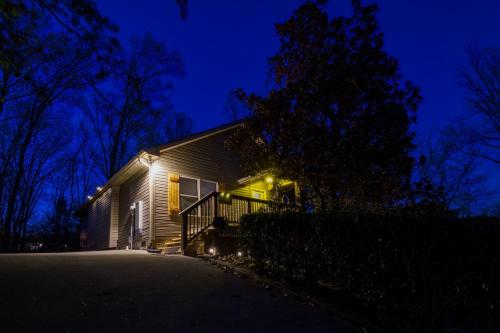 a house with lights on the side of it at night at Inn The Vicinity in Pigeon Forge