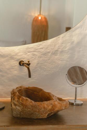 a bathroom sink with a faucet and a mirror at Anacardier Privé Hotel in Atins