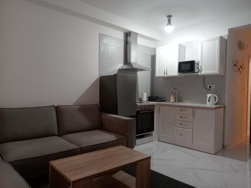 a living room with a couch and a kitchen at Green lime in Tivat