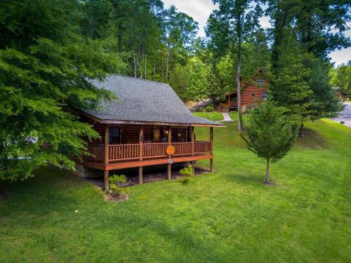 a log cabin in a field of green grass at A Smoky Getaway in Sevierville