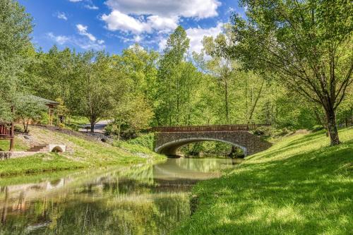 a bridge over a river in a park at A Smoky Getaway in Sevierville