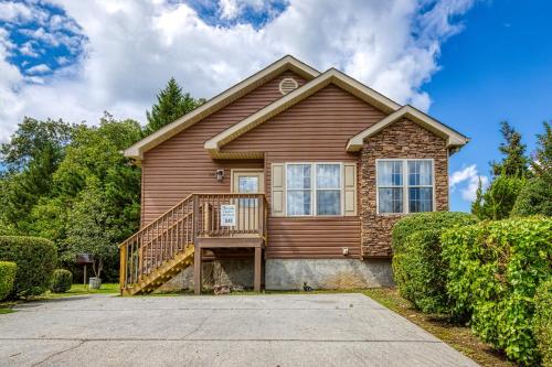 a brown house with a wooden at Striking Waters in Pigeon Forge