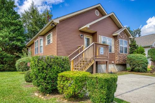 a house with a wooden staircase in a yard at Striking Waters in Pigeon Forge