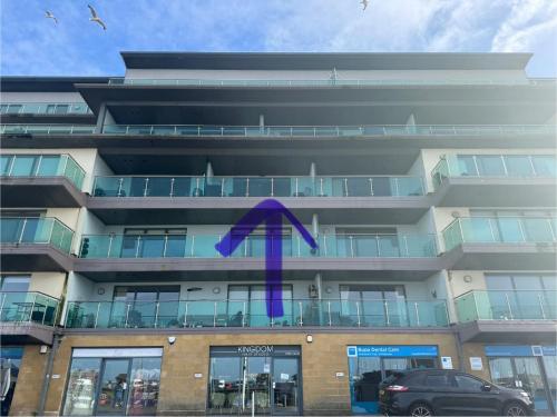 a building with a purple ribbon on it at Pears Suite - 1 Bedroom - Sleeps 2 in Whitehaven