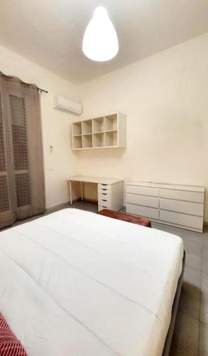 a bedroom with a large white bed in a room at Central Rooms Best Vacation Ever in Cagliari