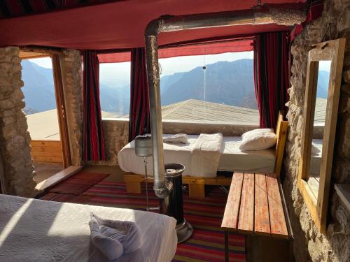 a room with two beds and a window with a view at Dana Trail Hotel in Dana