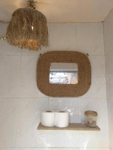 a bathroom with two rolls of toilet paper on a shelf at Casa La Alegria in Maçanet de la Selva