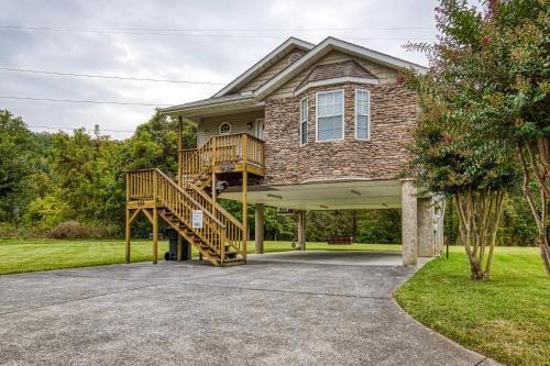 a house with a staircase in front of it at River Escape in Pigeon Forge