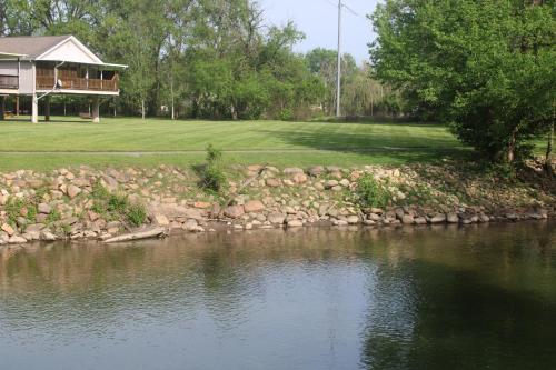 a house on a golf course with a pond at River Escape in Pigeon Forge