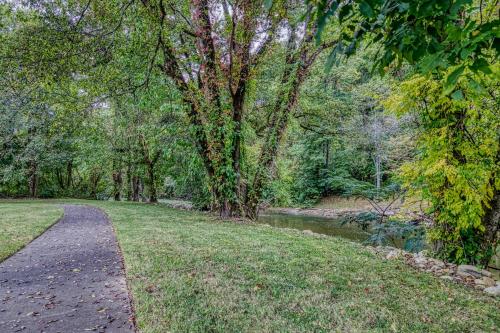 a path in a park next to a river at River Escape in Pigeon Forge