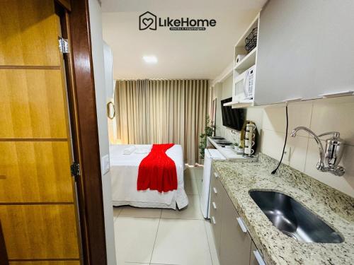 a small room with a bed with a red dress on it at Mar Bello in Ilha da Restinga