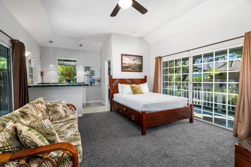 a bedroom with a bed and a couch at Kokua at Kona Bay Estates in Kailua-Kona
