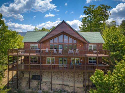 a large wooden house with a large deck at Getaway Mountain Lodge in Sevierville