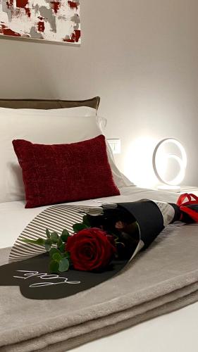 a bed with a bouquet of flowers on it at Casa Clerici 1956 in Erbusco