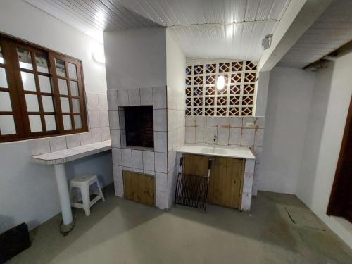 an empty bathroom with a sink and a counter at Beira Mar Pontal do Sul in Pontal do Paraná