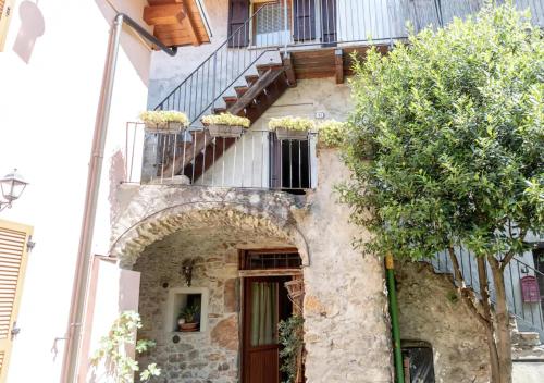 an old stone building with a door and stairs at Casa del Borgo in Bellano