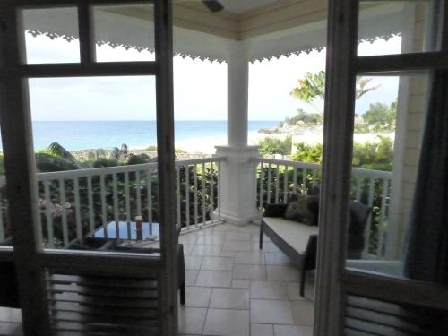 a screened in porch with a view of the ocean at Los Balcones in Sosúa